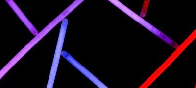 Purple blue and red neon straws on dark background
